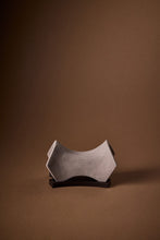Load image into Gallery viewer, Carved stone diffuser sculpture and cast metal plate on brown background.